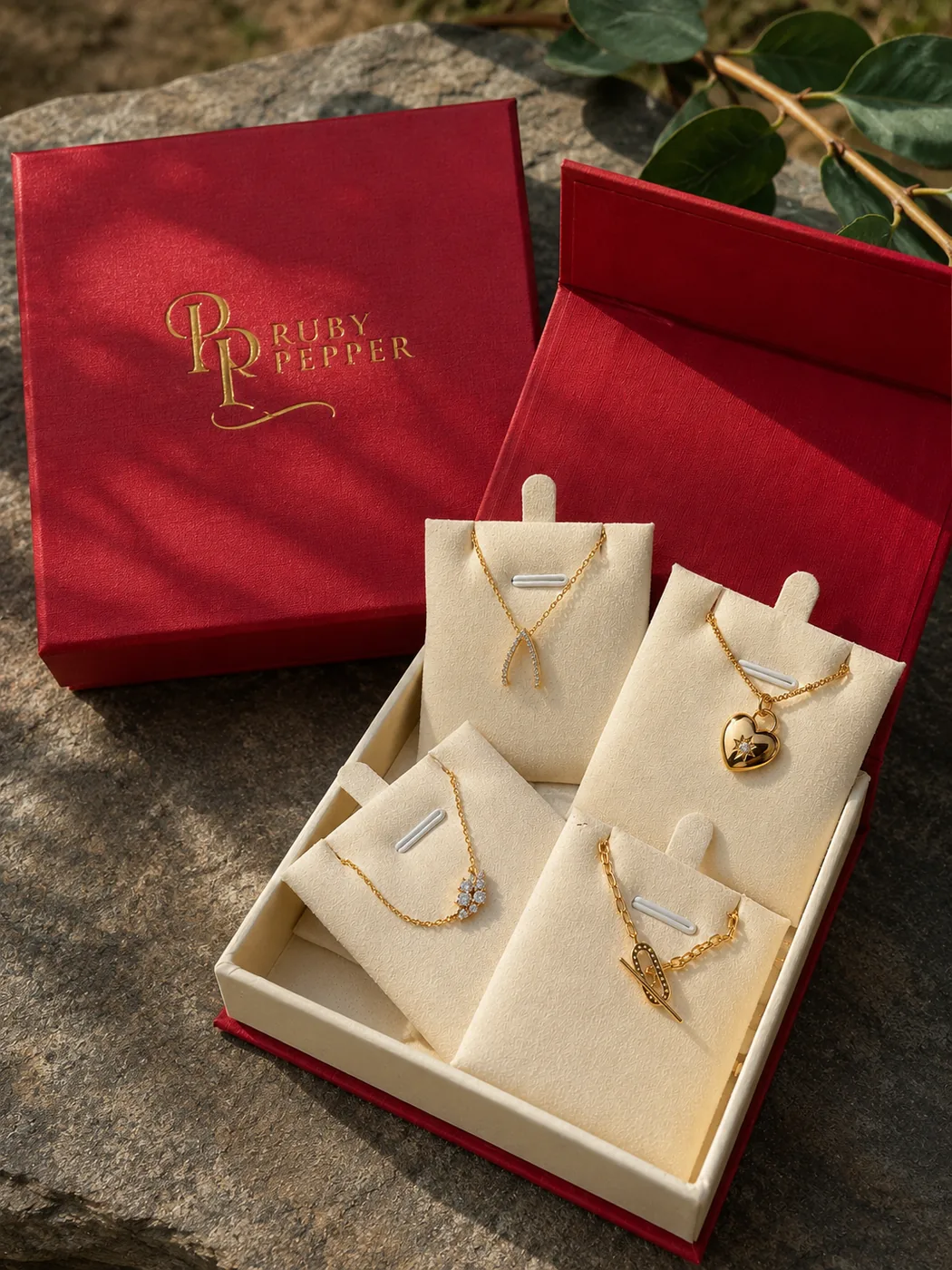 Ruby Pepper gift box of necklaces on stone with greenery