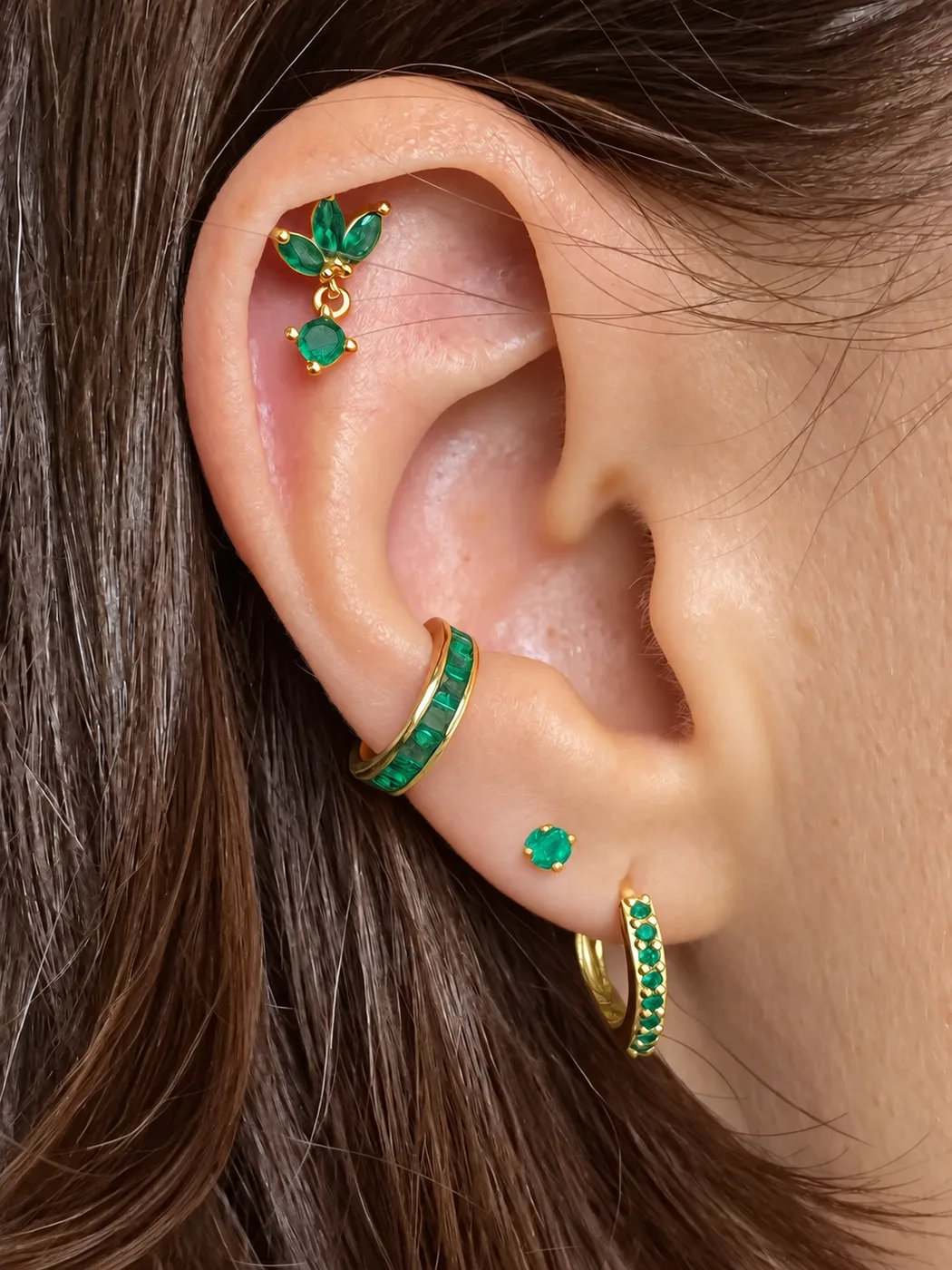 Emerald green ear stack with a leaf helix stud, baguette cuff and pavé hoop