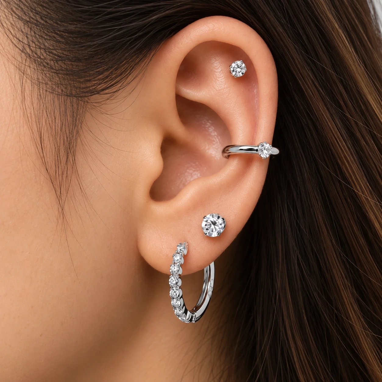 Silver crystal helix stud with a single crystal ear cuff, round crystal lobe stud and a pavé silver huggie hoop