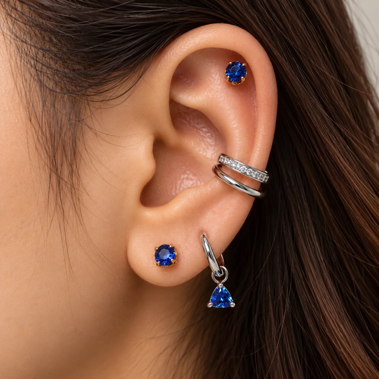 Sapphire crystal studs with a pavé double band cuff and a silver huggie with a sapphire trillion charm