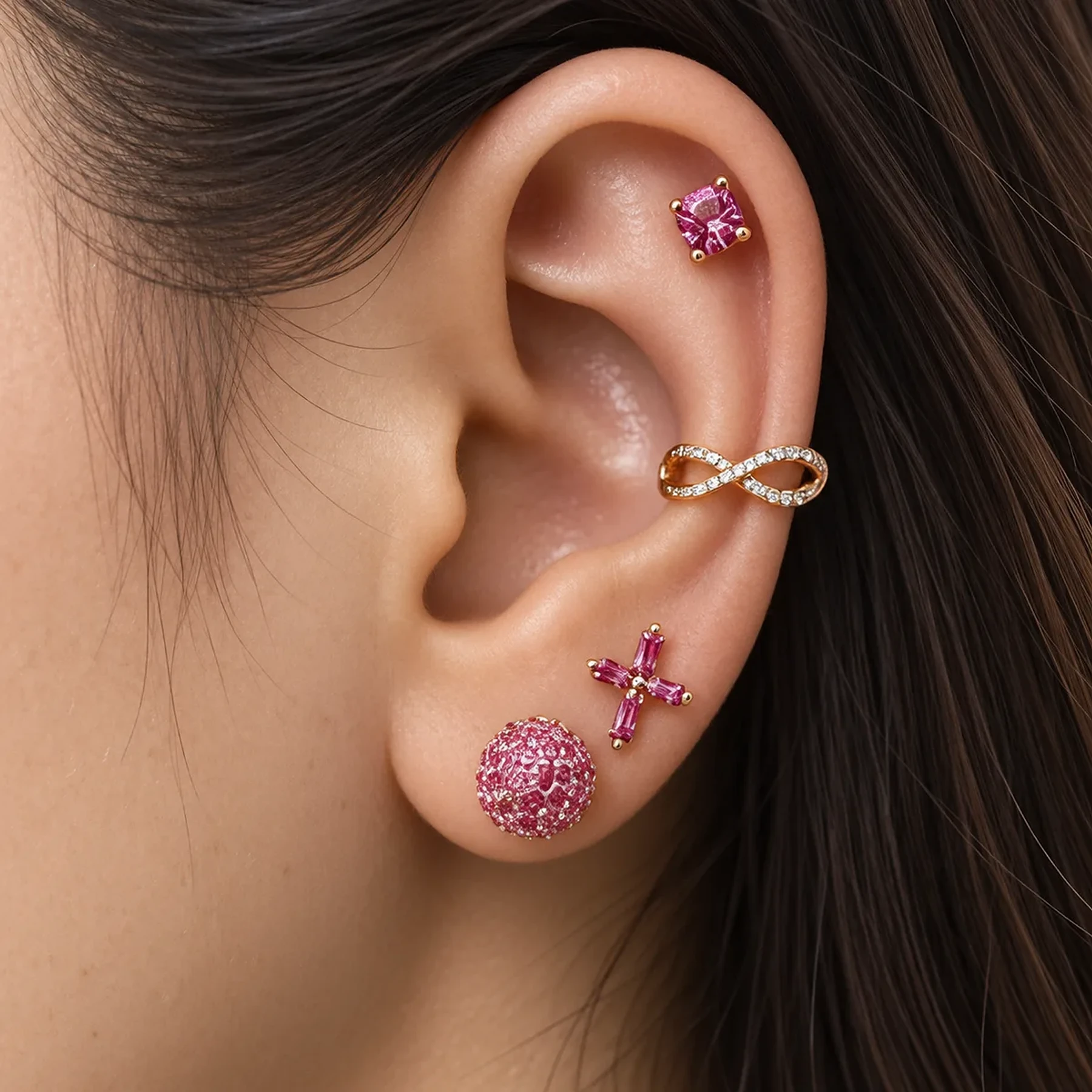 The Rosie Blush ear stack: pink crystal studs, a rose gold crossover cuff and a pink cross stud